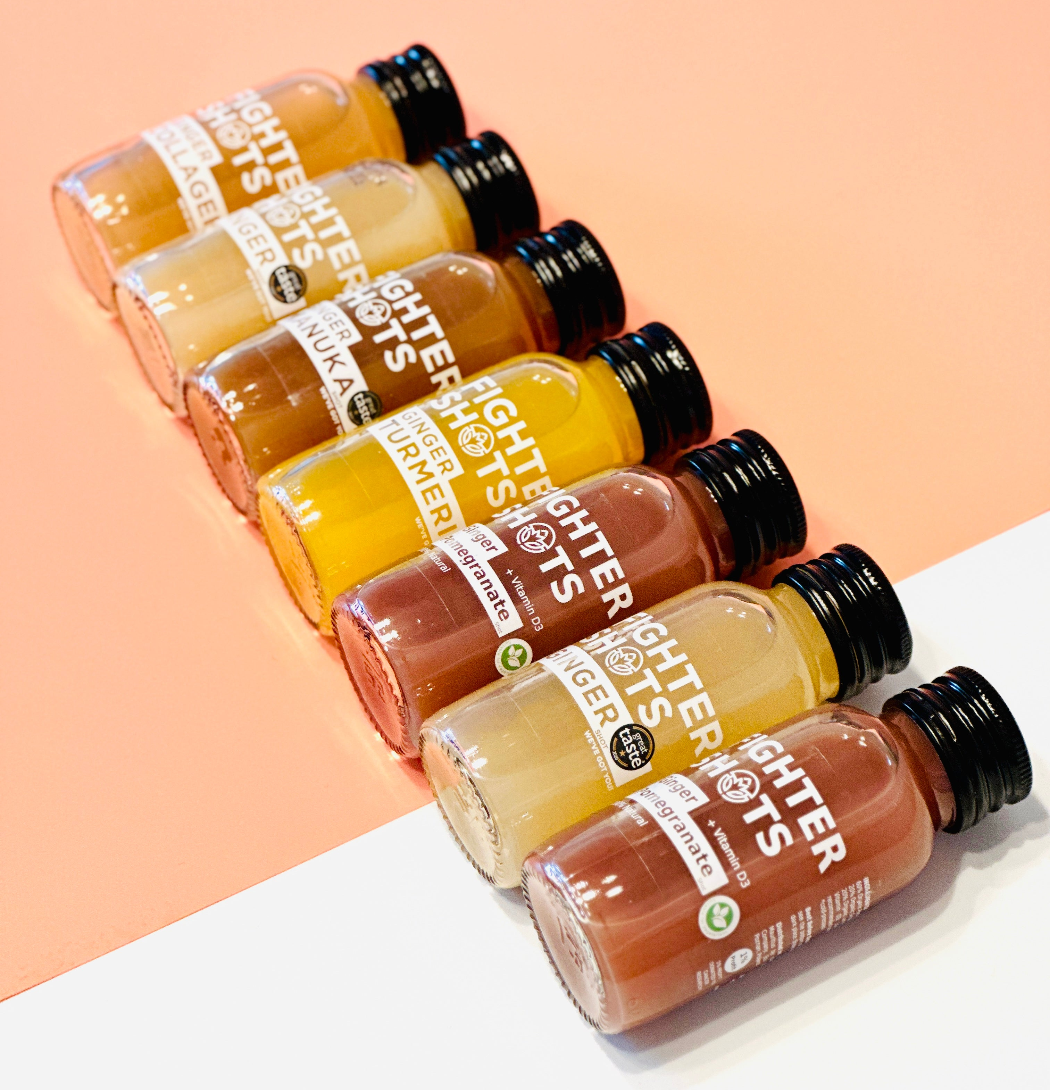 Set of small bottles with different colored liquids on a two-tone background